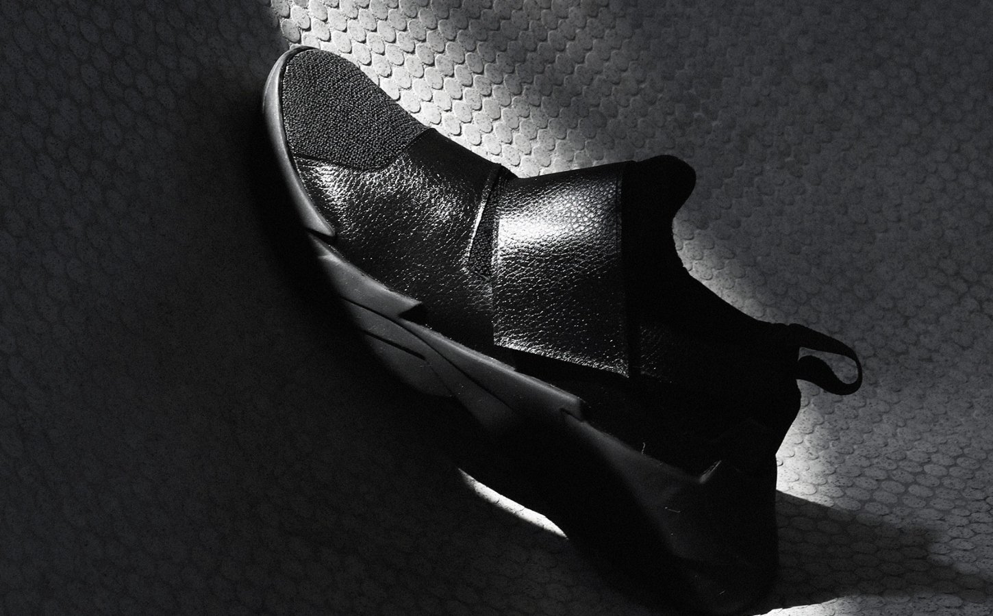 vegan shoe against a dark shadowy background
