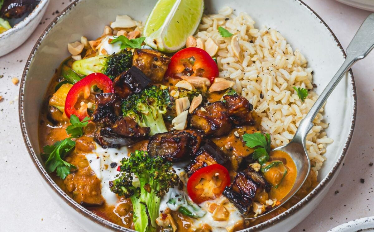 a bowl of roasted aubergine and broccoli lentil curry with brown rice as part of vegan broccoli recipes